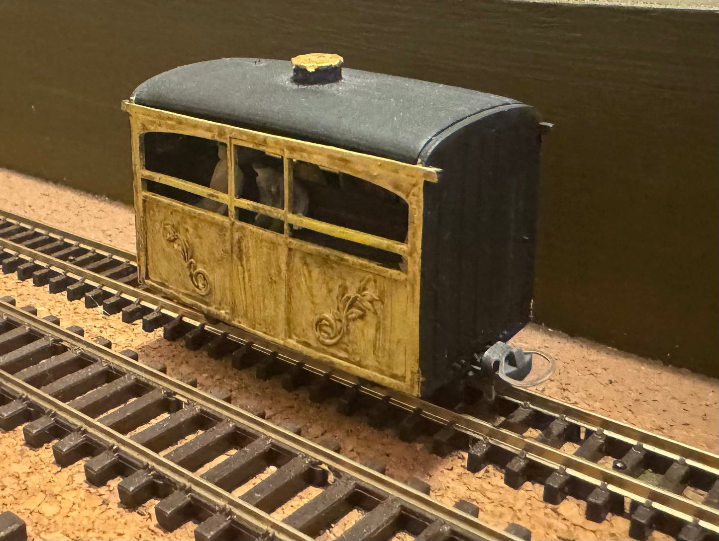KD Railways (OO9) Open Side “Bug box” coach with fitted passengers.