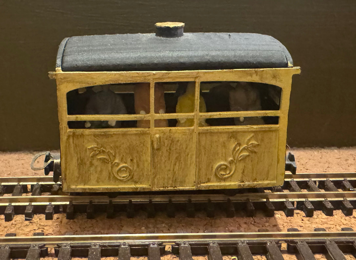 KD Railways (OO9) Open Side “Bug box” coach with fitted passengers.